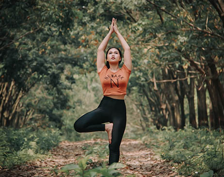 Woman in yoga pose in a forest