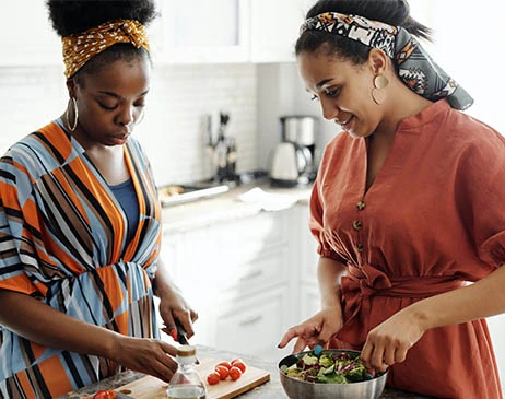 Two women preparing a meal together