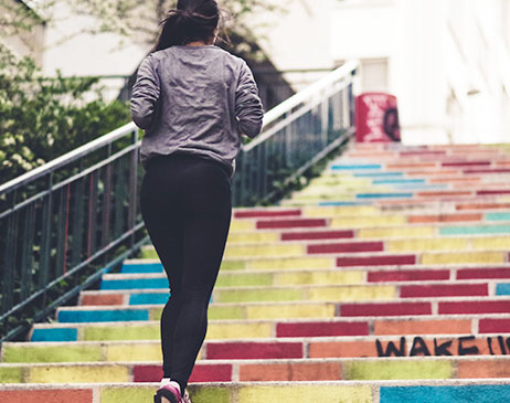 Woman running up stairs