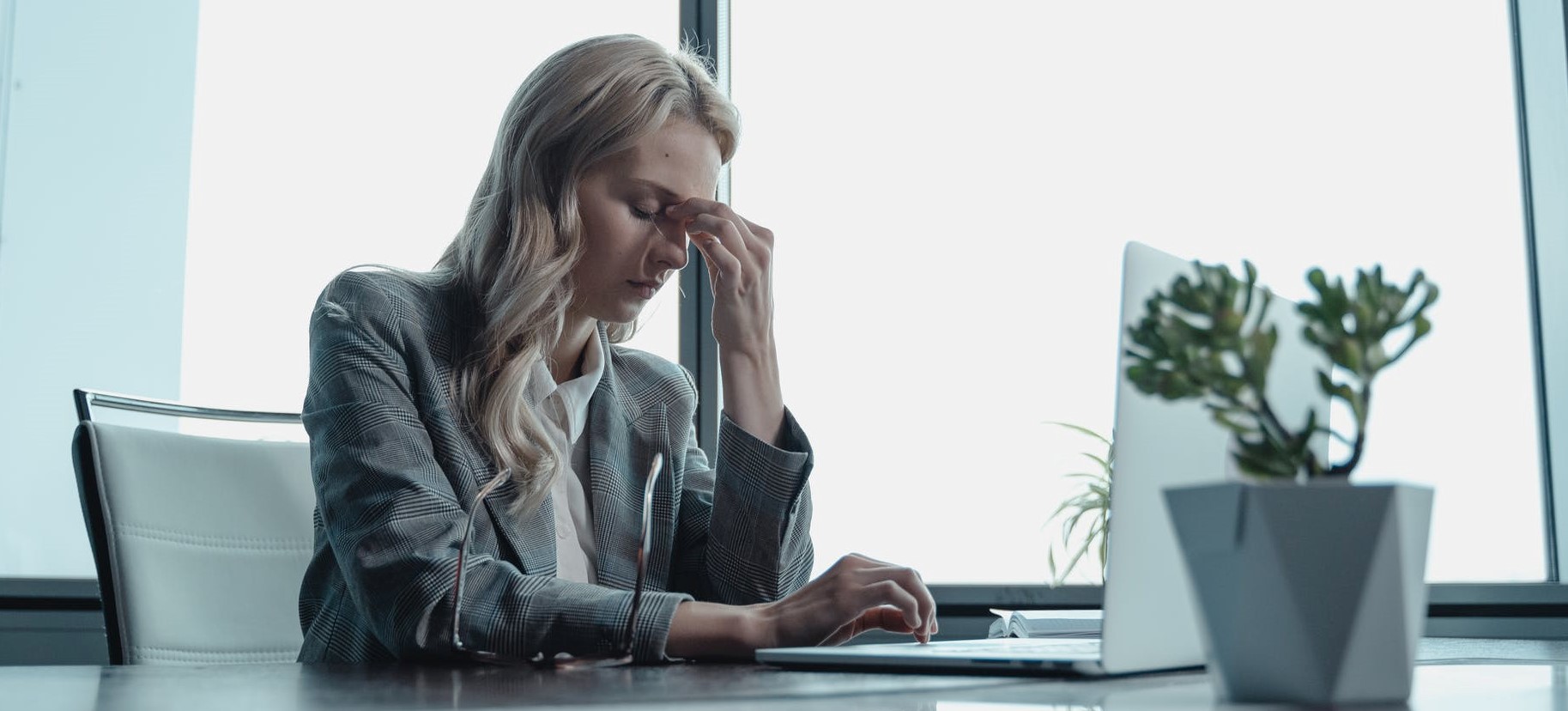 Woman sitting at desk stressed