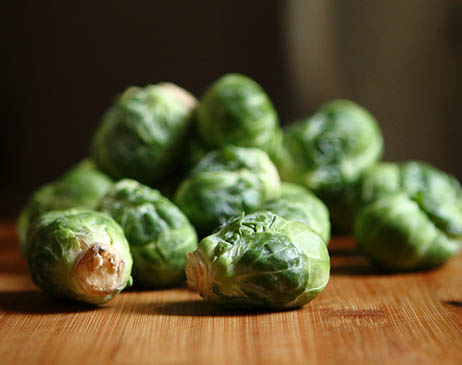 Raw brussel sprouts on a chopping board