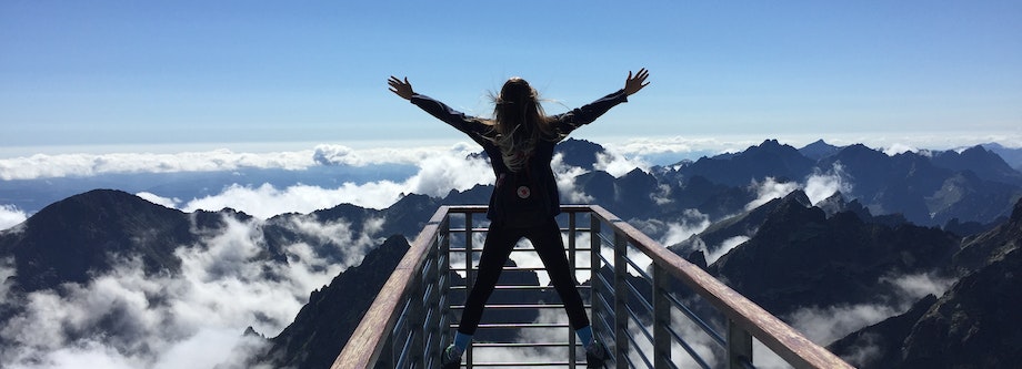 Woman celebrating with mountains in the background